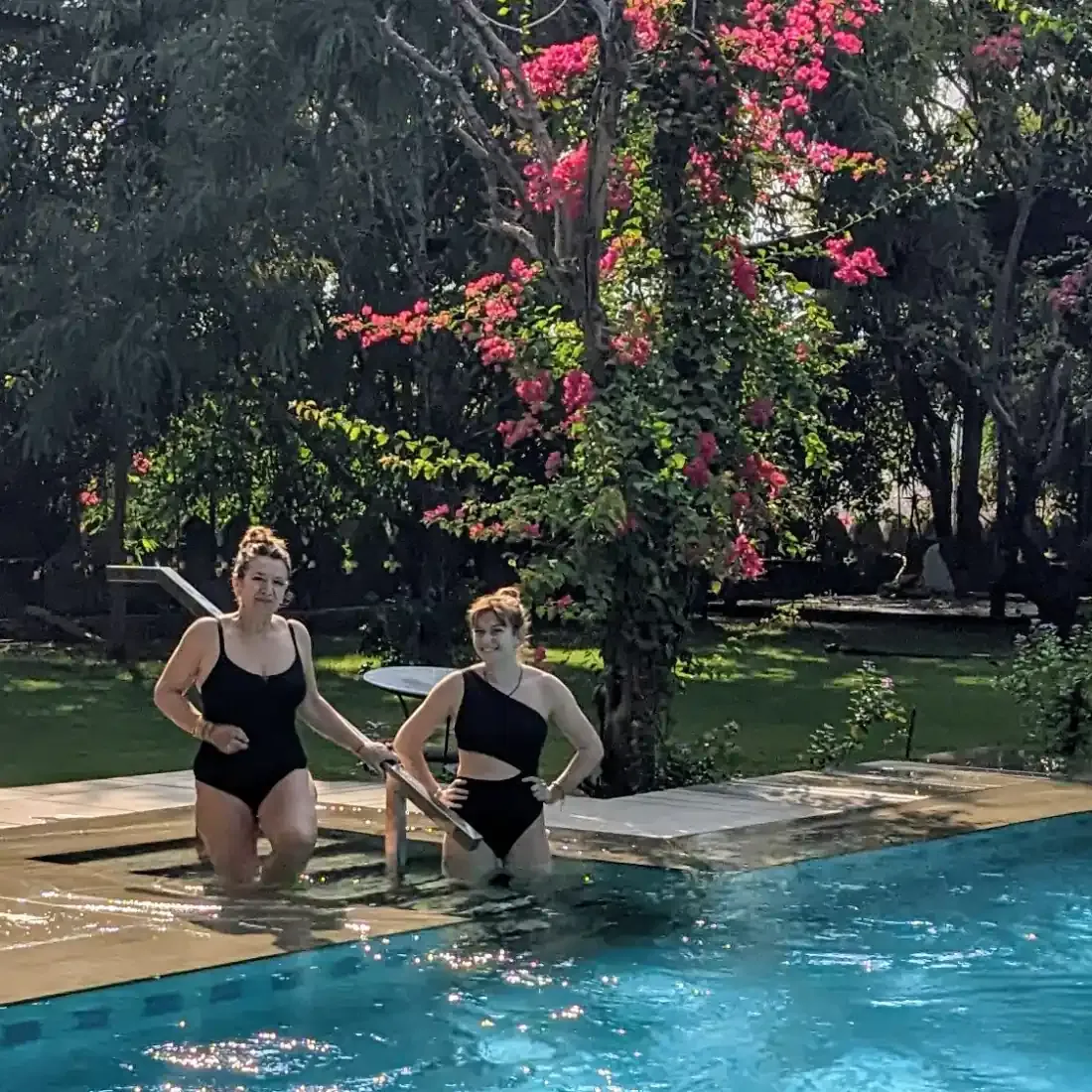 Two guests standing in the shallow end of the pool