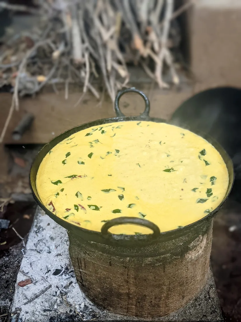 Kadhi cooking slowly over the wood fire