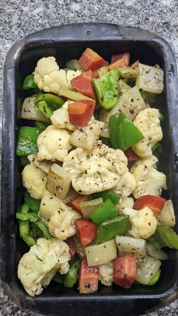 Mixed vegetables on a black tray