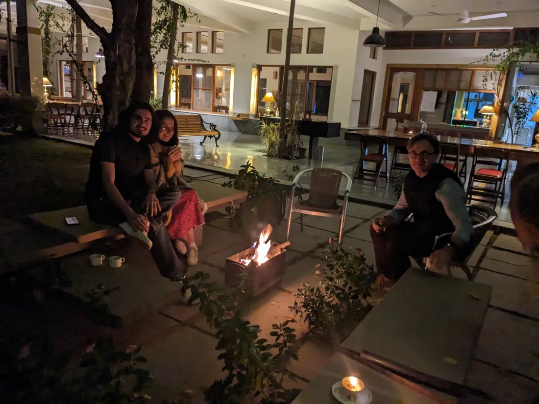 Guests around the firepit at dusk — PushkarOrganic
