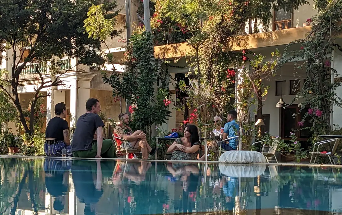 Guests talking together beside the pool