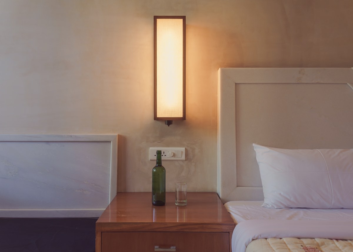 Bedside table — lamp, bottle, surface
