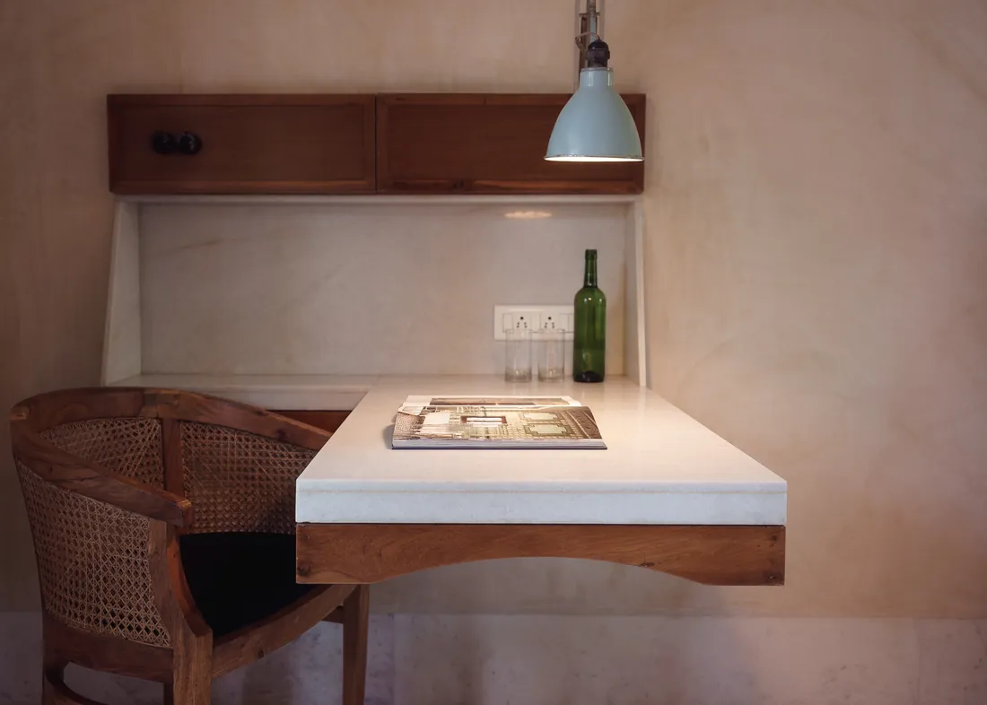 Illuminated stone writing desk and cane chair in the Deluxe room