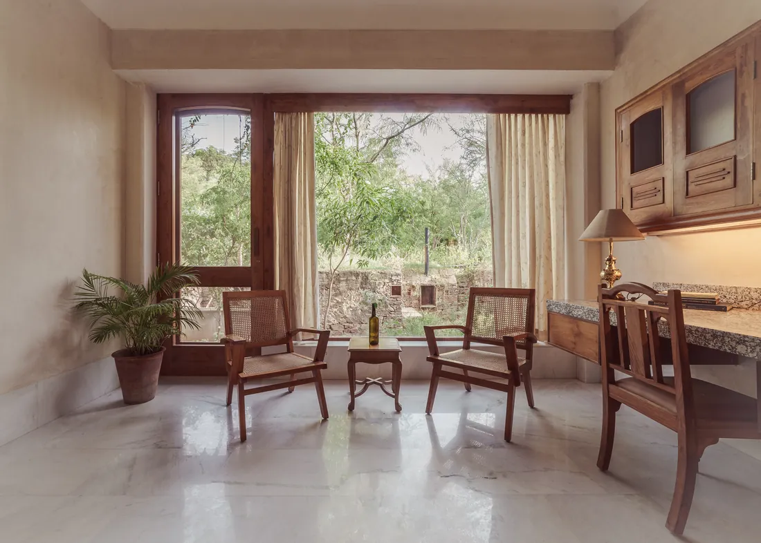 The Suite work area — cane chairs, desk, and the garden window